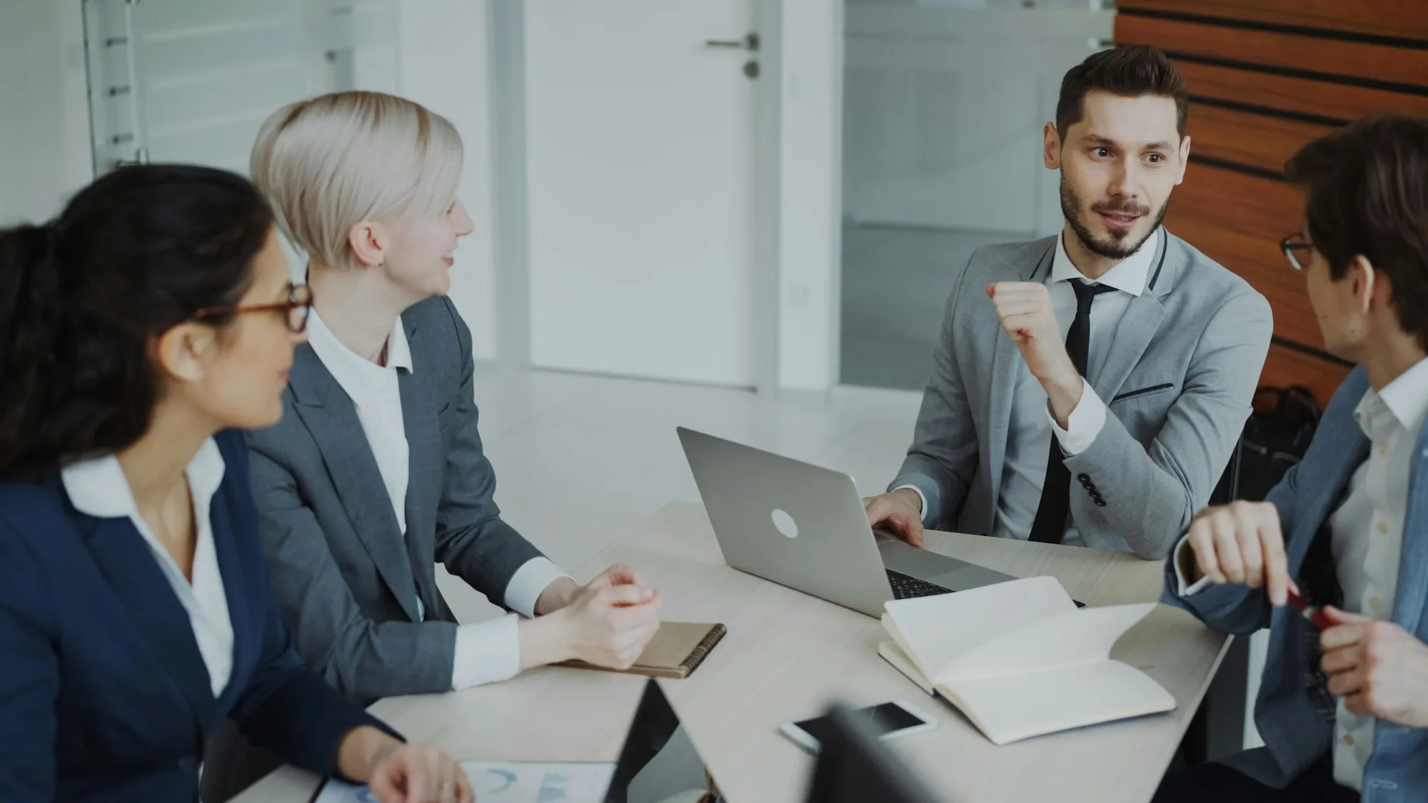 Business meeting around a table with laptops